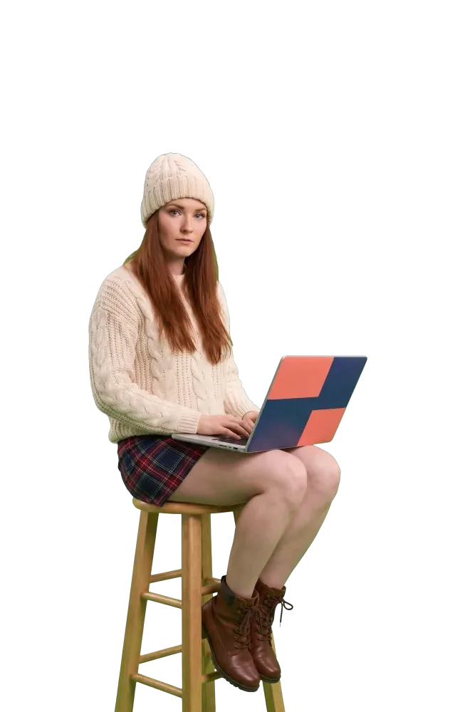 Woman on a stool working on a laptop