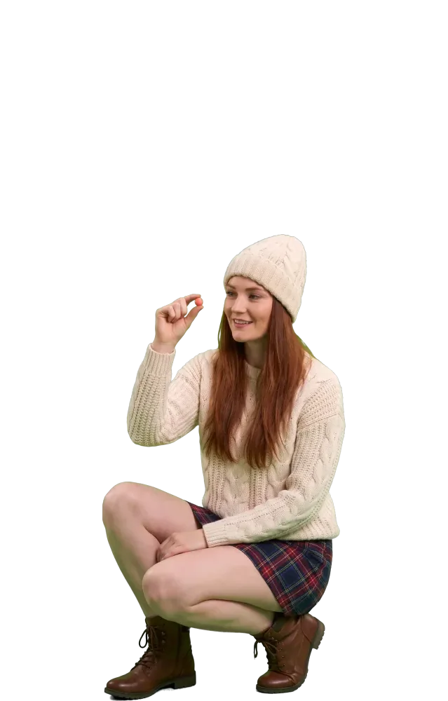 Crouching woman examining a tiny ball