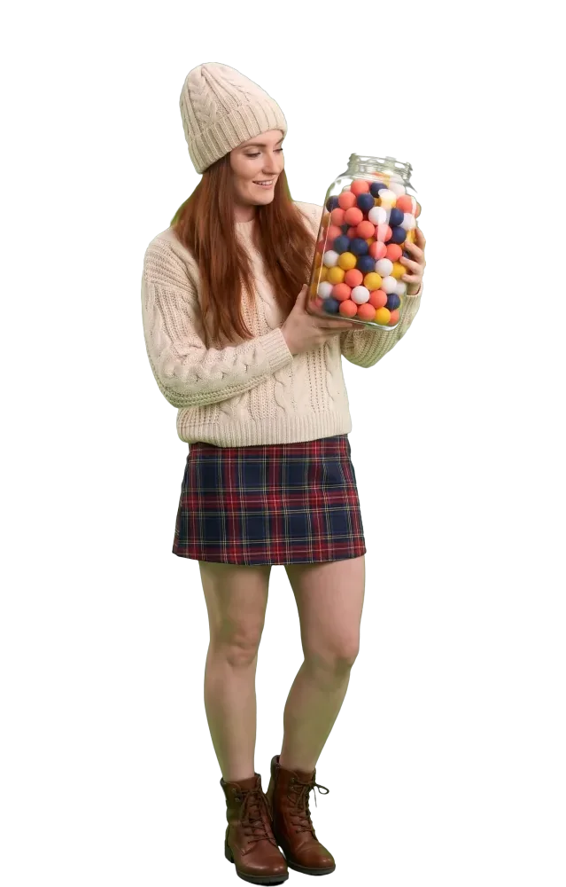 Woman looking at a jar packed with coloured balls