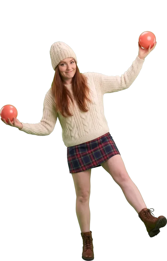 Woman balancing on one foot with a ball in each hand