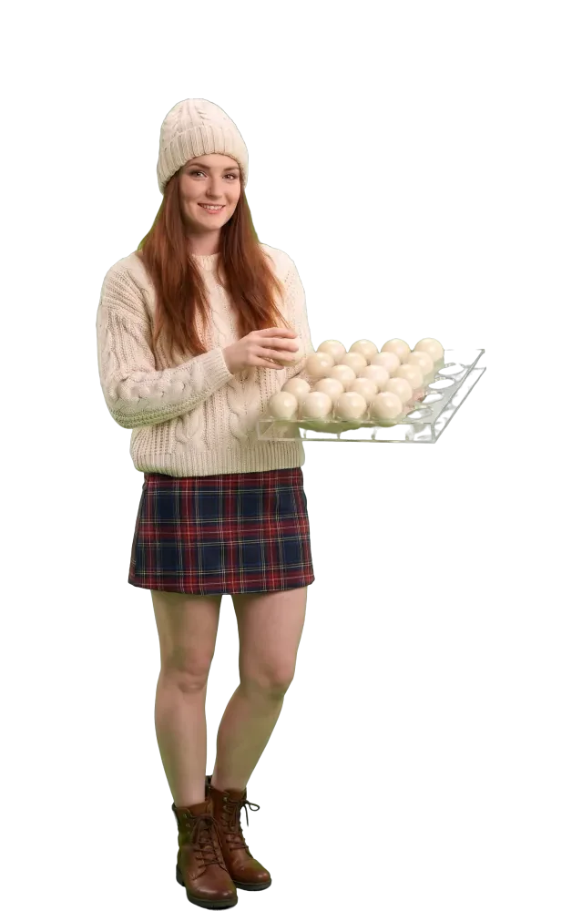 Woman placing the last ball in a tray of slots