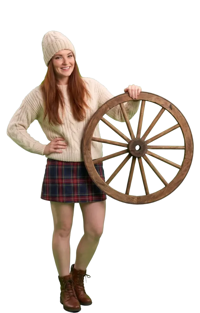 Woman standing with a wooden wagon wheel