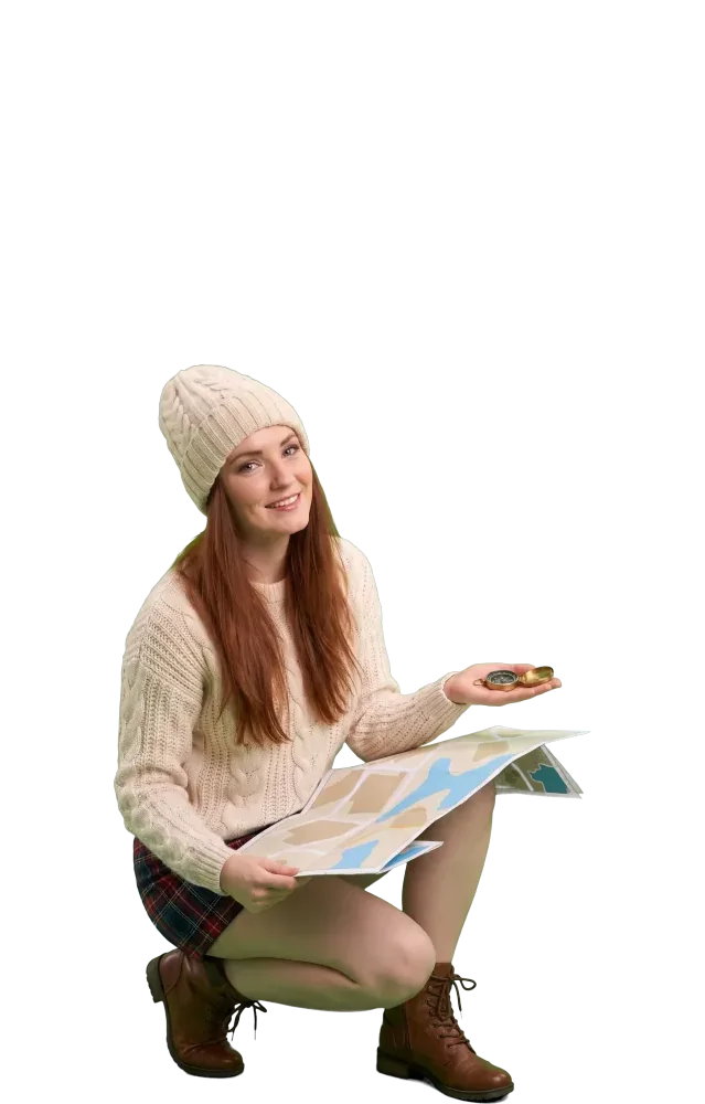 Crouching woman with a paper map and a compass