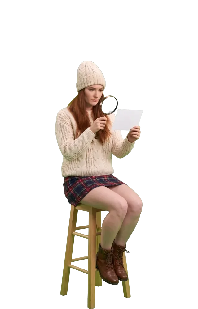 Woman on a stool reading a card through a magnifying glass