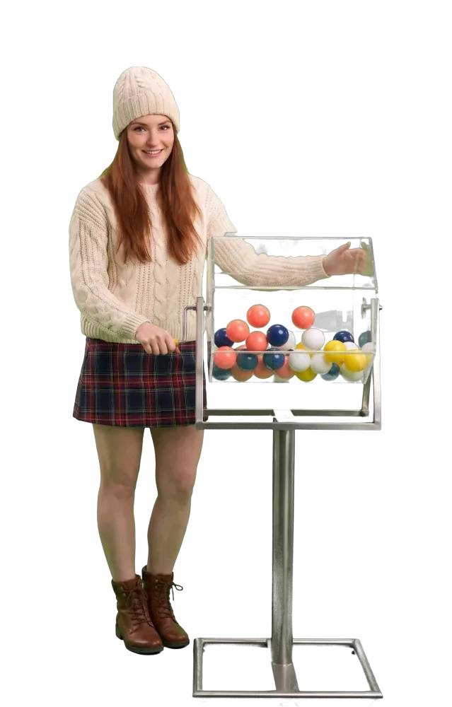 Woman turning the crank of a large lottery drum